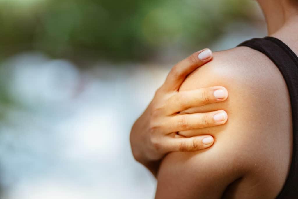 Woman clutching shoulder in pain